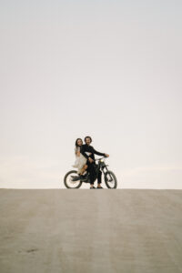 Couple rides e motorcycle in Joshua Tree desert elopement